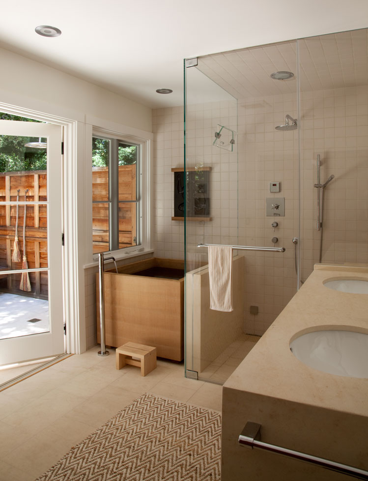 The new bathroom features a Japanese 'ofuro' or soaking tub. It opens onto a landscaped patio with an outdoor shower. Photography: Leslie Williamson. Landscape design: Feyerabend and Madden