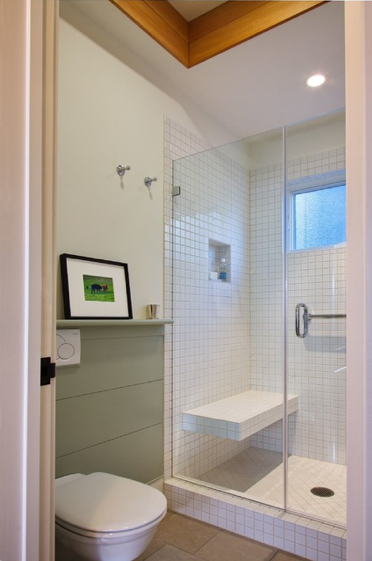 The horizontal wainscot panels, warm grey, limestone tile and fir trims give the space a modern simplicity.
