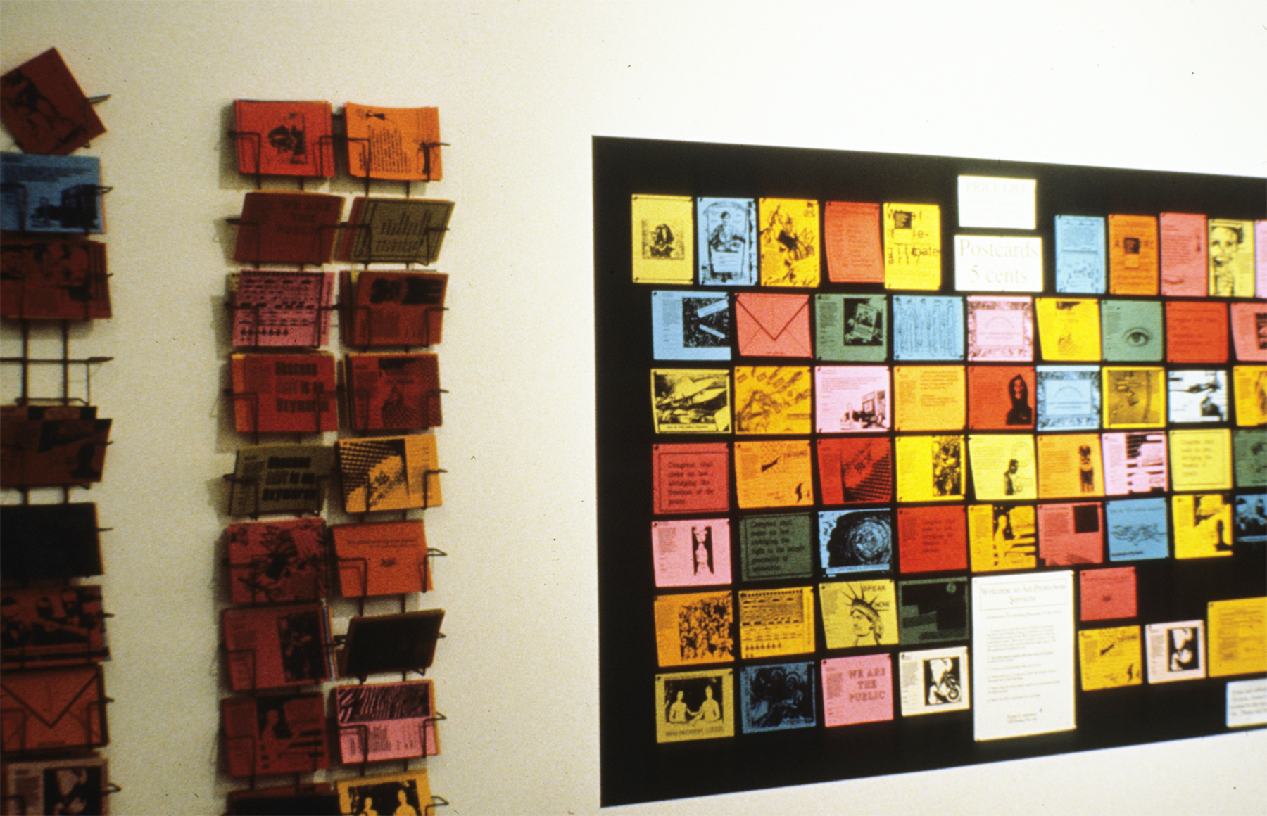 ART PROTECTION SERVICES: Karen Atkinson and Associates, ARTtorneys At Work. Artists were asked to create postcards to send to the National Endowment for the Arts Reauthorization Committee. Each postcard had images and text asking the committee to consider not censoring artists and to reauthorize the NEA. The view could buy a set of postcards along with the pre-printed address labels and postage. There was a post office box right outside the gallery.