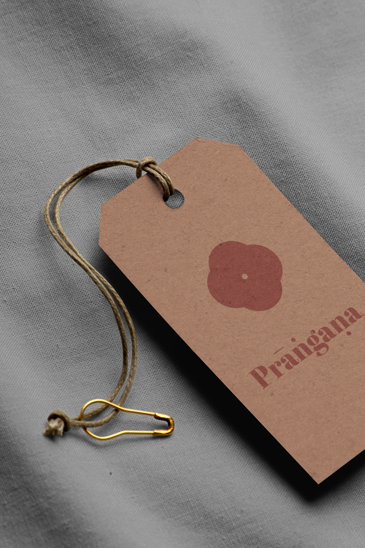 minimal-mockup-featuring-a-cardboard-brand-tag-lying-on-a-solid-color-fabric-27636.png