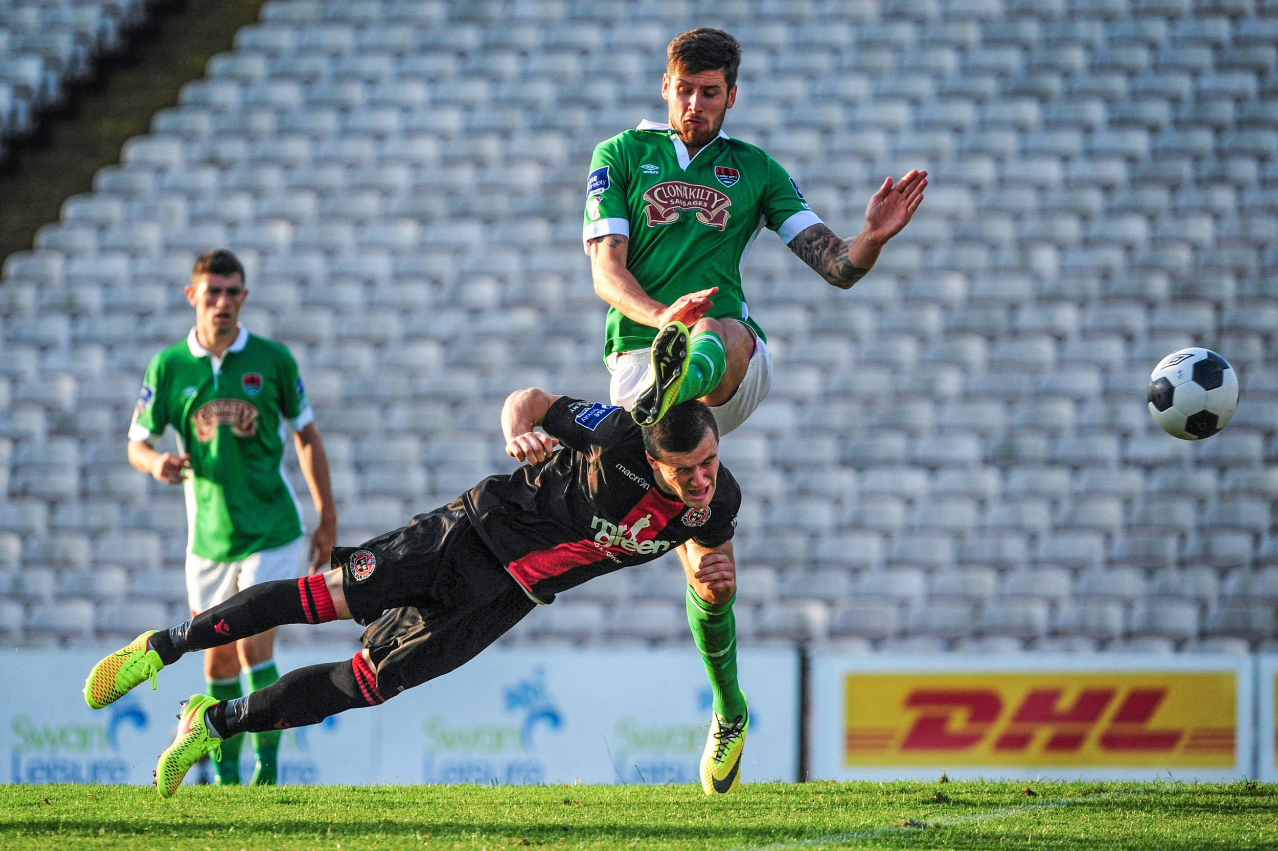 Steven Beattie of Bohemians scores his side's winning goal despite the tackle of Darren Dennehy of Cork City at Dalymount Park in Dublin 2014. Beattie would leave the game with a concussion after the play.&nbsp;/&nbsp; Sportsfile  