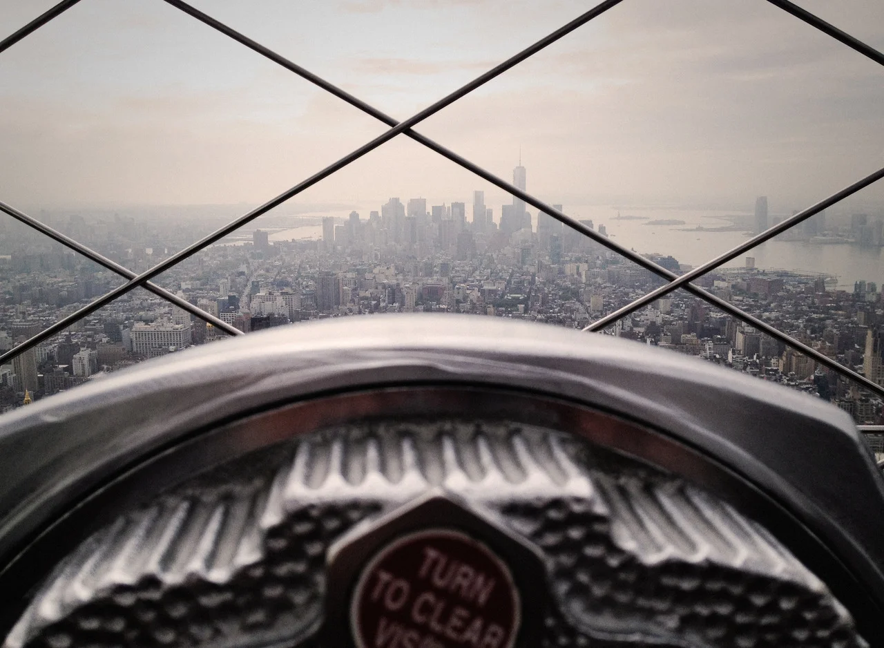 A beautiful shot of New York City, from far up in the clouds. Image via unsplash .