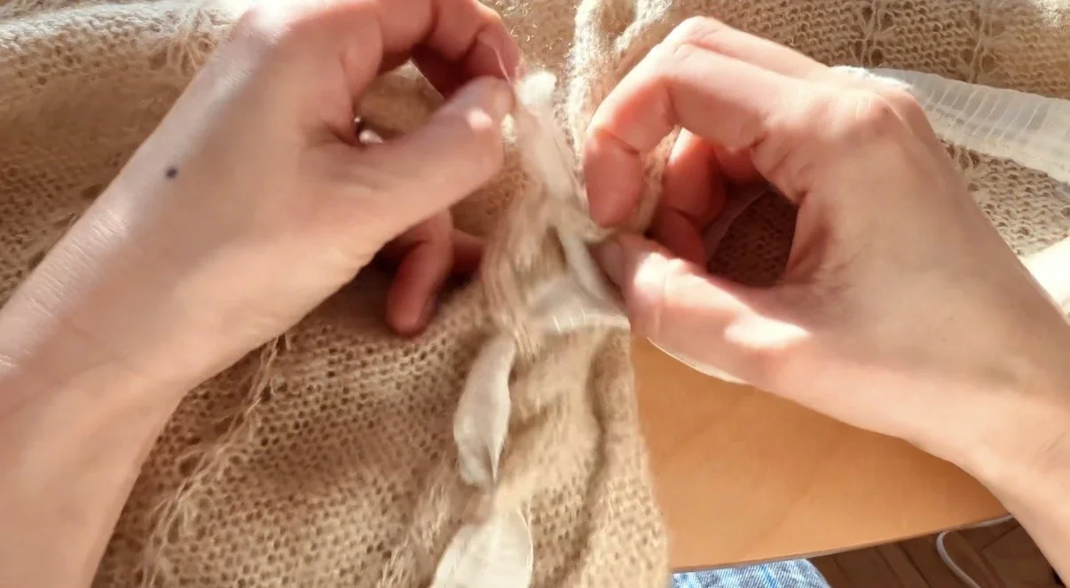 A close-up shot of upcycled cable knit sweater by Aloha Picnic