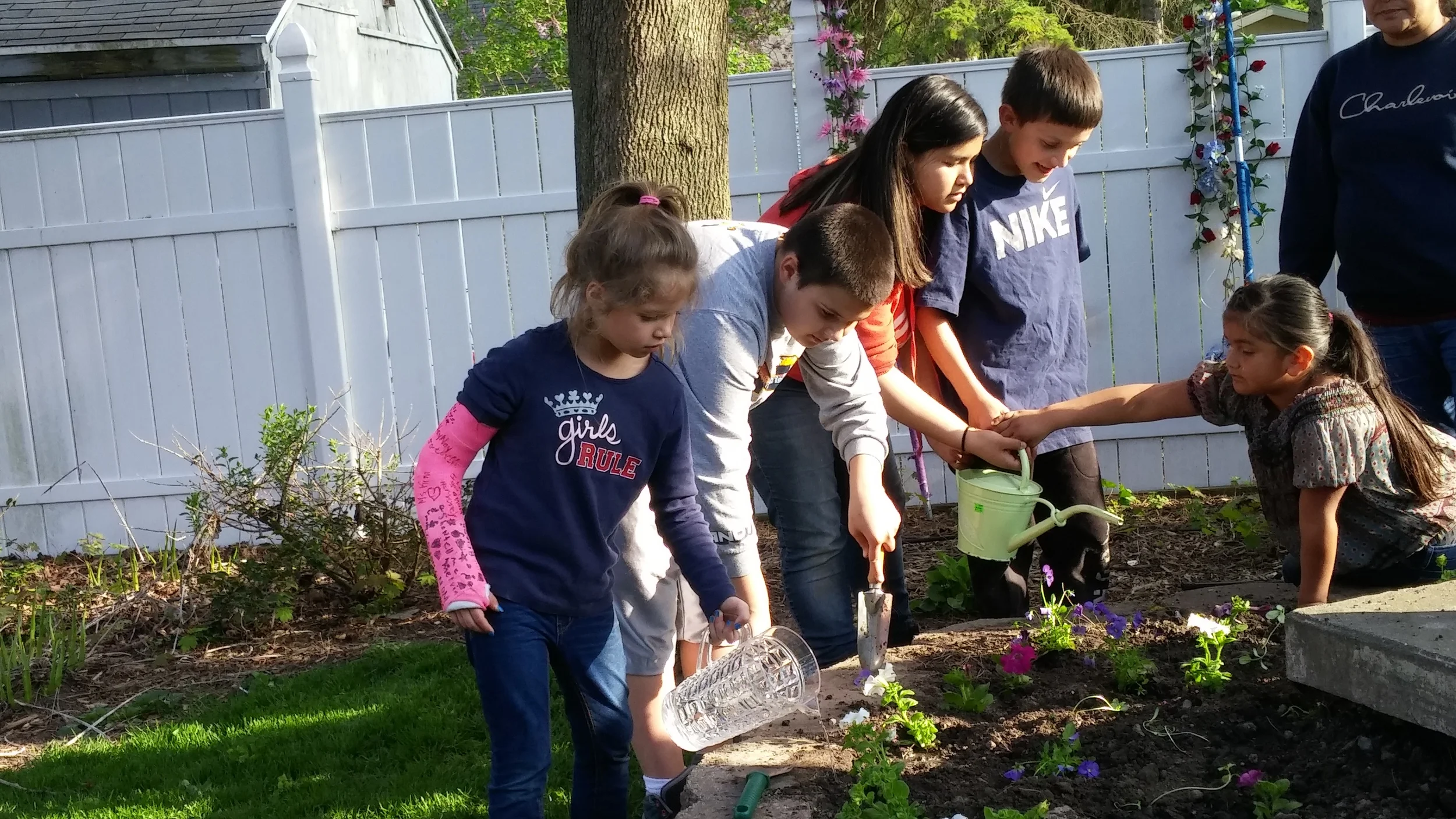Everyone worked together to plant and water flowers!
