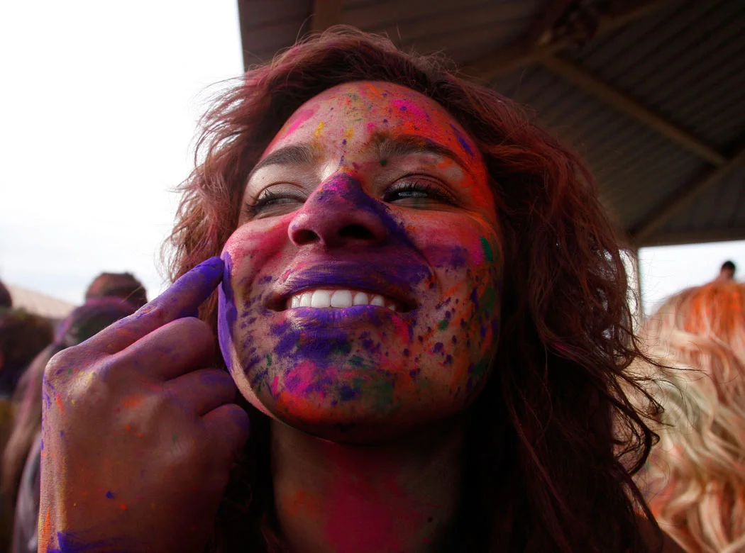 Michelle Diez gets some purple on her face during the Holi Festival of Colors at the Krishna Temple in Spanish Fork on Saturday, March 24, 2012.