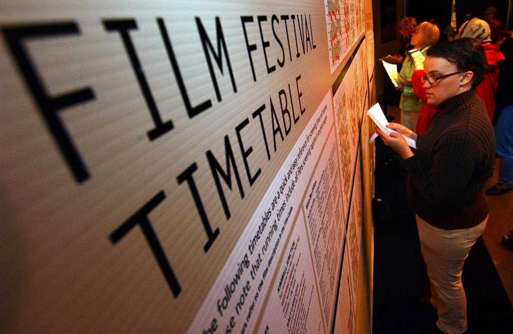 Sundance Film Festival Volunteer Mya Drexler checks the timetable at the Sundance Box Office in Park City, Utah.