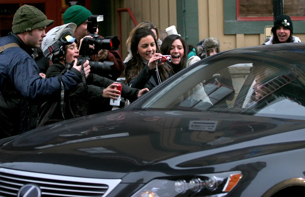 Fans and photographers swarm Adrian Grenier as he gets in a car on Main Street during the Sundance Film Festival.
