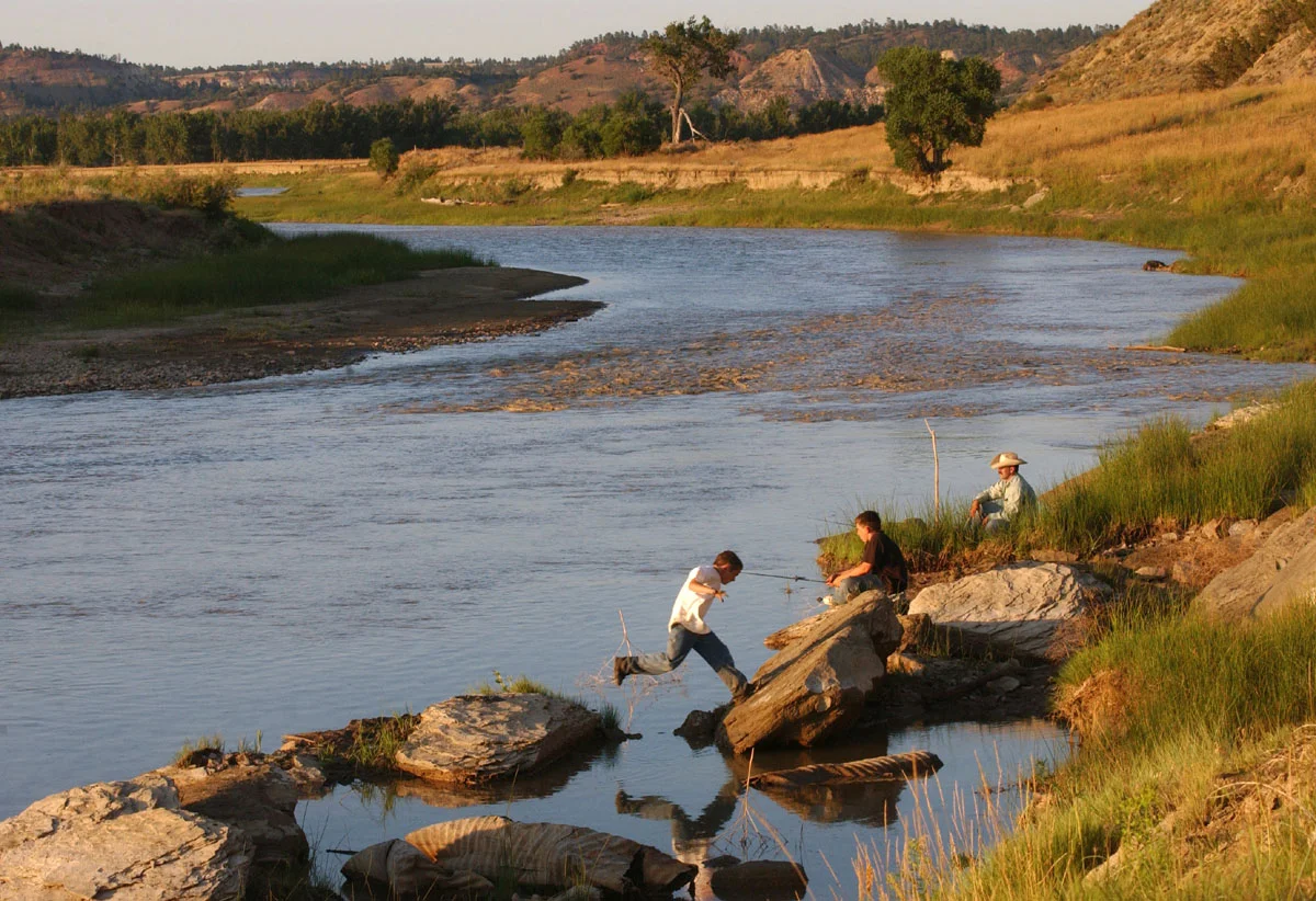  Tudor Rogers and his grandsons savor an evening of catfishing on the Powder River, behind Rogers' ranch.  J.M. Huber began dumping methane product water into the Powder River in the fall of 2005. A few studies are underway to monitor any effects pro