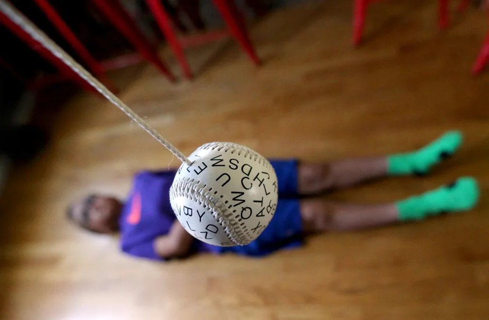  A ball with letters on it swings back and forth over Lota Ward as he tries to focus on the moving letters to improve his eye sight at home in Layton on Wednesday, May 4, 2016. His fourth brain surgery for a teratoma tumor impaired his left eye's abi