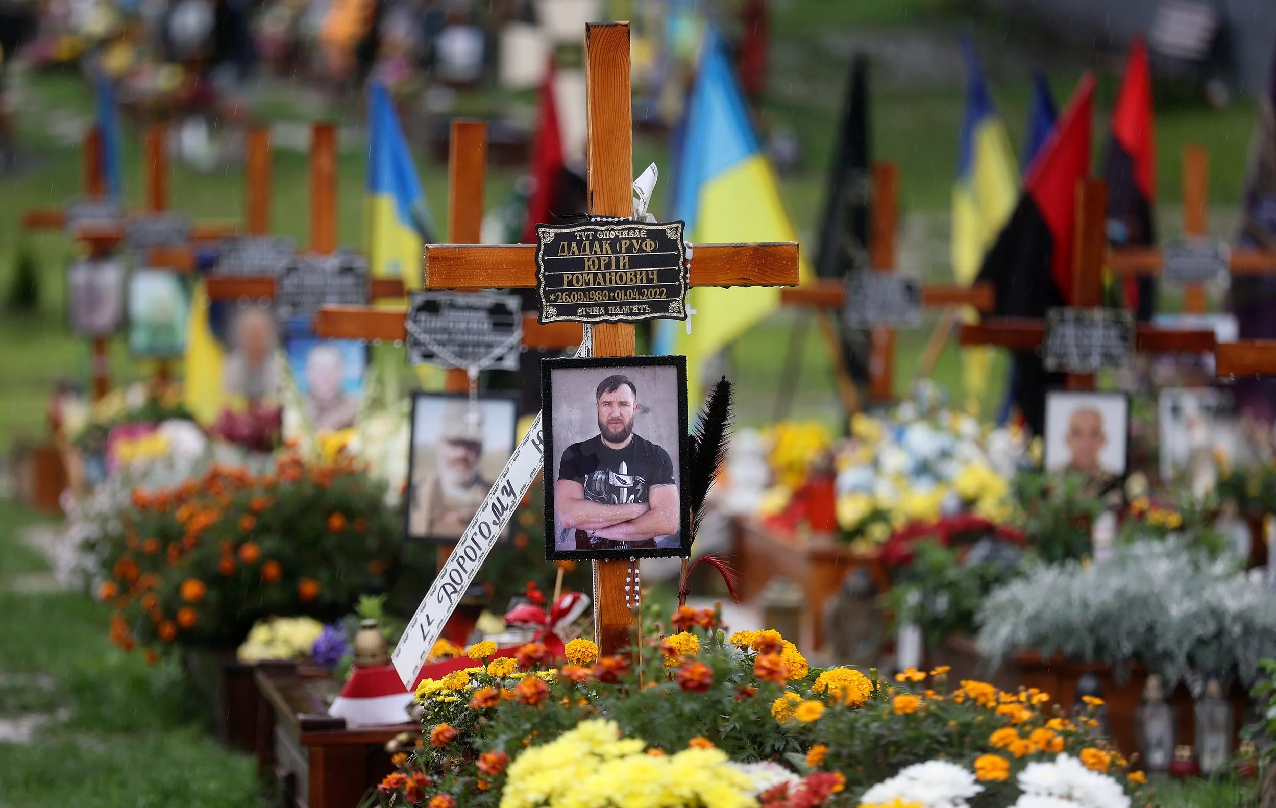  Graves of Ukrainian soldiers killed during the war with Russia are decorated with flowers, flags and photos in an overflow area just outside the fence of the historic Lychakiv Cemetery in Lviv, Ukraine, on Sunday, Sept. 18, 2022. 