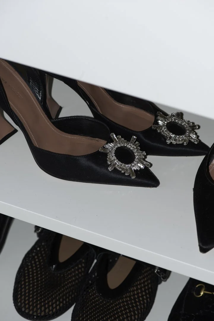 product photography of luxury shoes styled in a closet on shelving