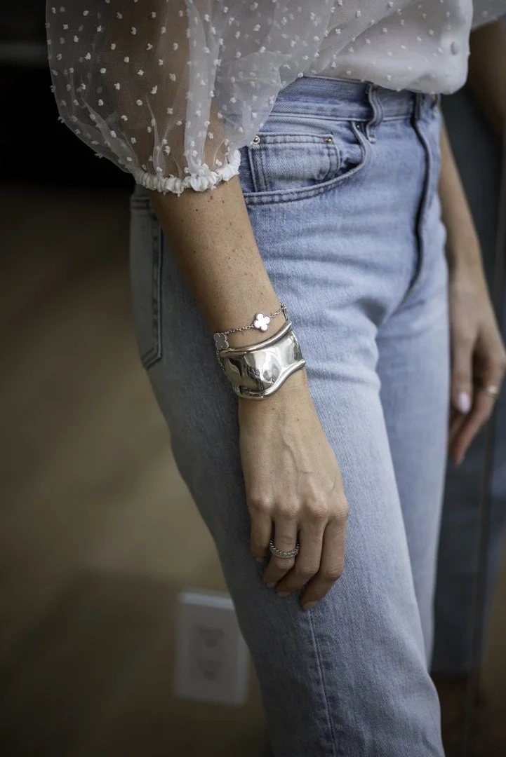 product photography and branding photography of a woman's arm wearing a chunky silver bracelet 