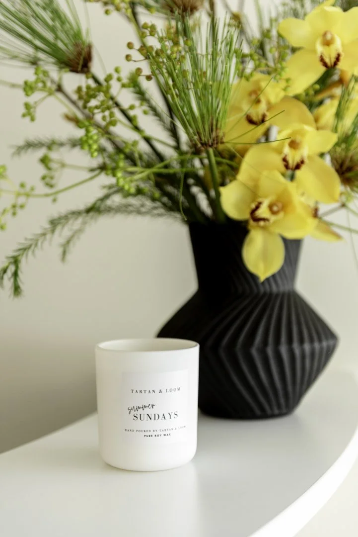 interior photography and product photography of a bouquet of flowers arranged inappropriately modern geometric vase and a candle by Tarten & Loom
