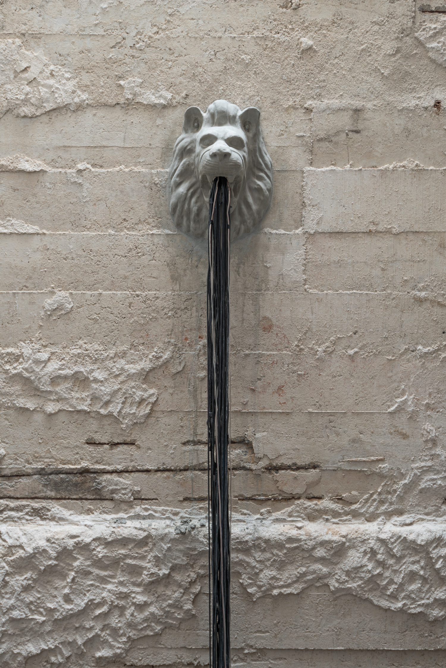 Fonte , 2014 Cabeça de leão, em cimento, usada como ornamento em fontes de jardins e 200 kg de cabos de fonte de eletro-eletrônicos. 6 m x 2,5 m x 2, 5m Foto: Édouard Fraipont