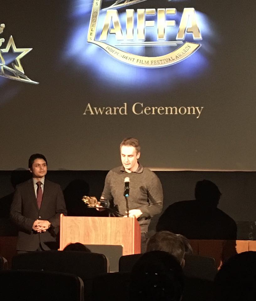 Director Shawn Lebert recieving the Best Picture award.