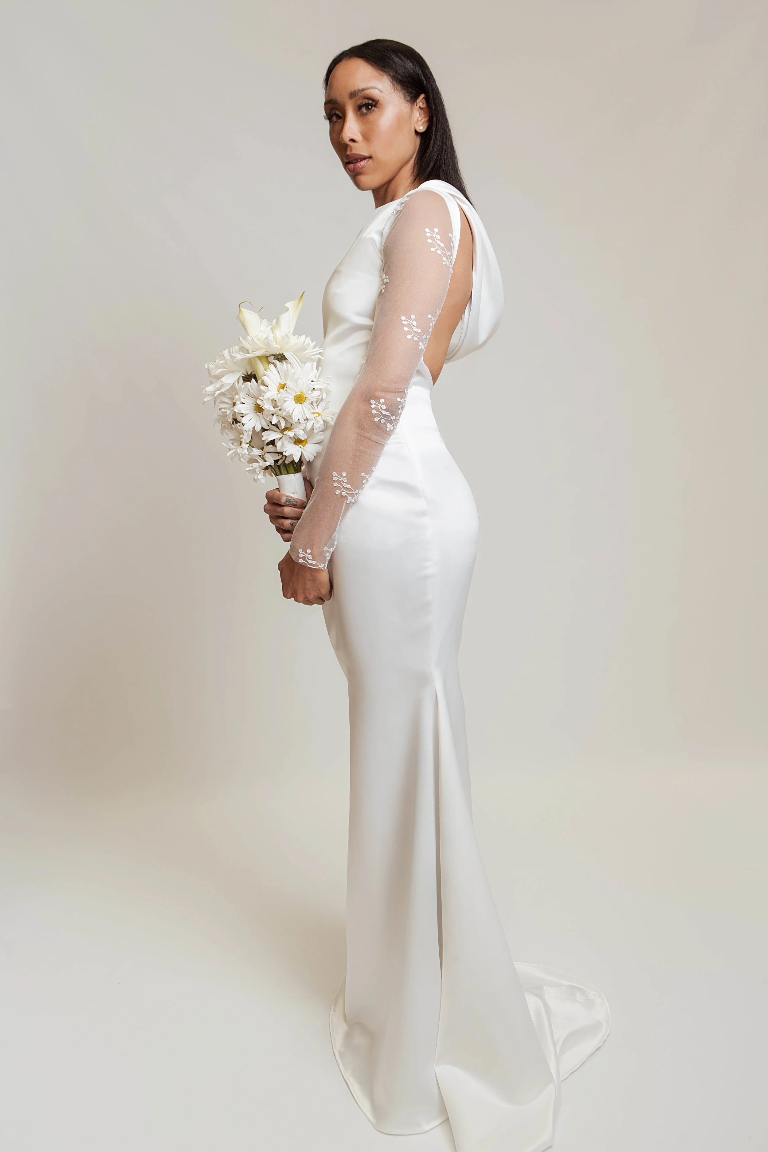 Mermaid style gown in a pearl white satin twill, stretch lace mesh sleeves, bias cut cowl neckline, and open back detail.