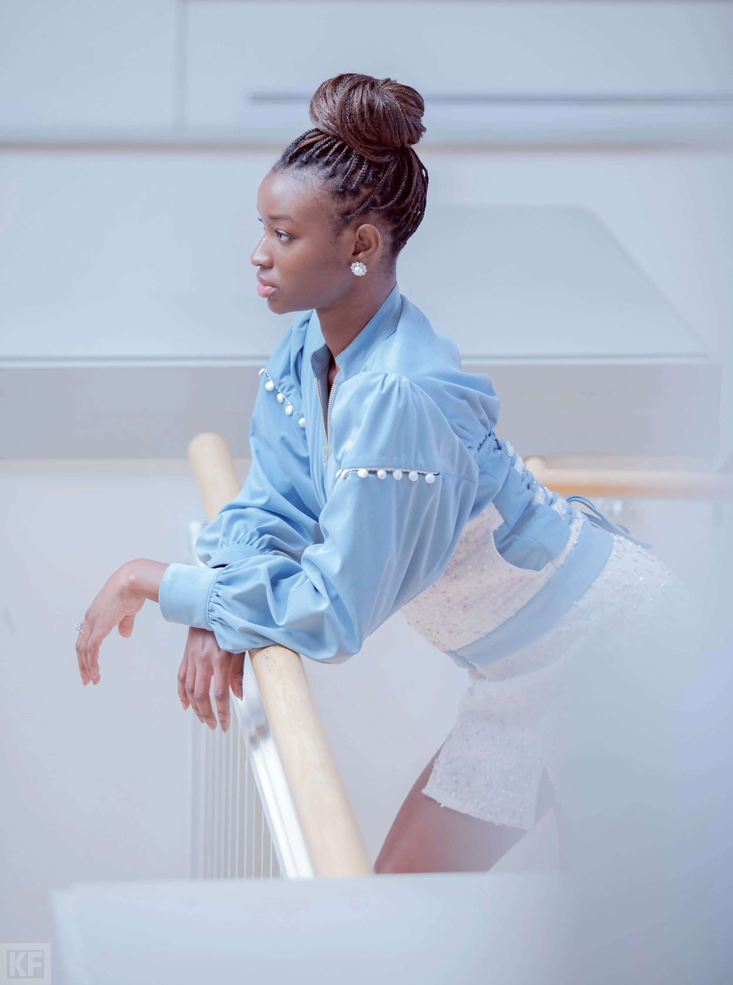 Model in light blue suede and tweed jacket with tweed skirt