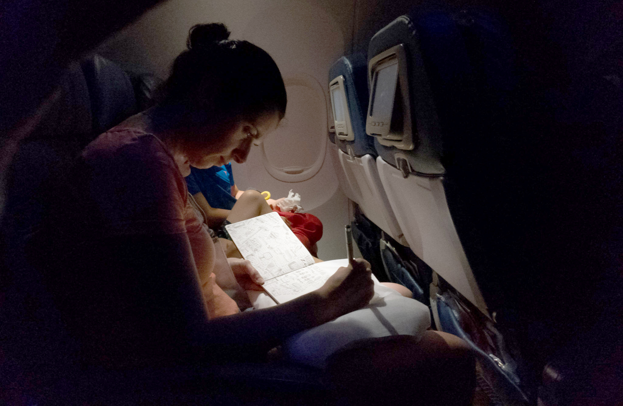 Finishing a drawing on an overnight flight. Thanks to the husband and family paparazzo, Matthew, for capturing it! xo