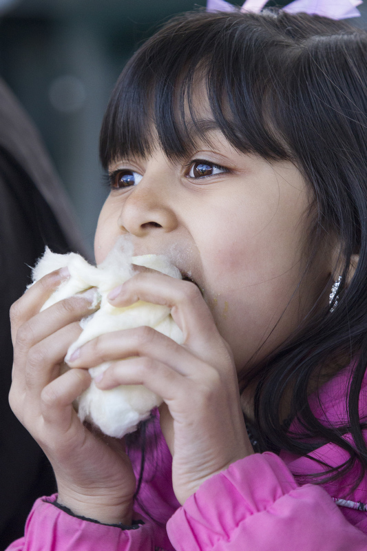 Kamiel Bhola eats cotton candy at her first ever baseball game. 