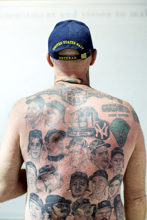 Claude Godfrey attended his first Yankees game in 1970 and served in the Navy from 1976 to 1980. He has Yankees tattoos all over his body including faces of hall-of-famers on his back. 