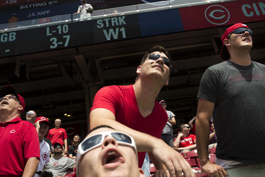Fans look up as a batting practice home run enters the bleachers.