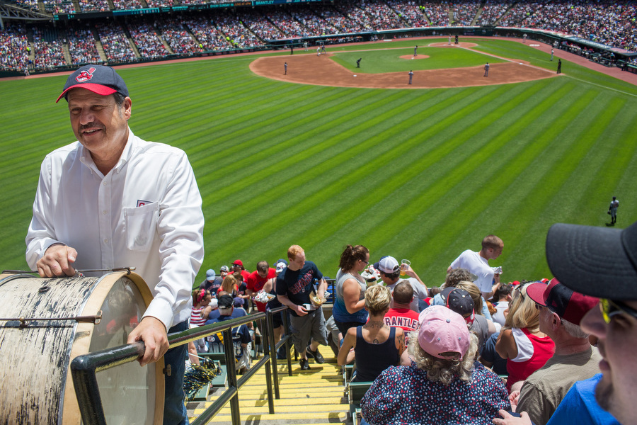 John Adams walks up the bleacher stairs with his bass drum to take his customary position in the top row. He's played that drum at more than 3000 games since 1973.