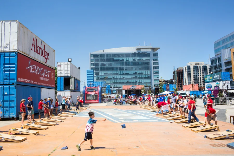 There can be up to 25 games of bags going on at once across the street from the stadium at Fairgrounds, an area constructed with old shipping containers that's open before and after Nationals games. 