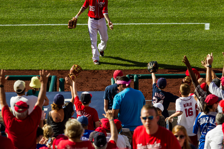 Nationals first baseman Adam LaRoche throws a ball into the stands.