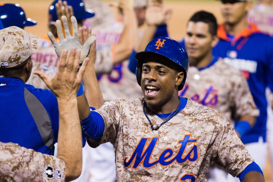 Mets outfielder Curtis Granderson who tied the game in the eighth inning with a solo home run high fives with teammates after the win. 