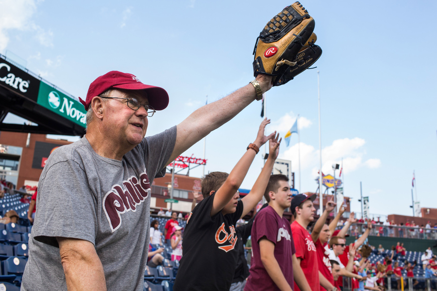 Ted Schearer, far left, goes early to batting practice to catch balls for his grandkids. 