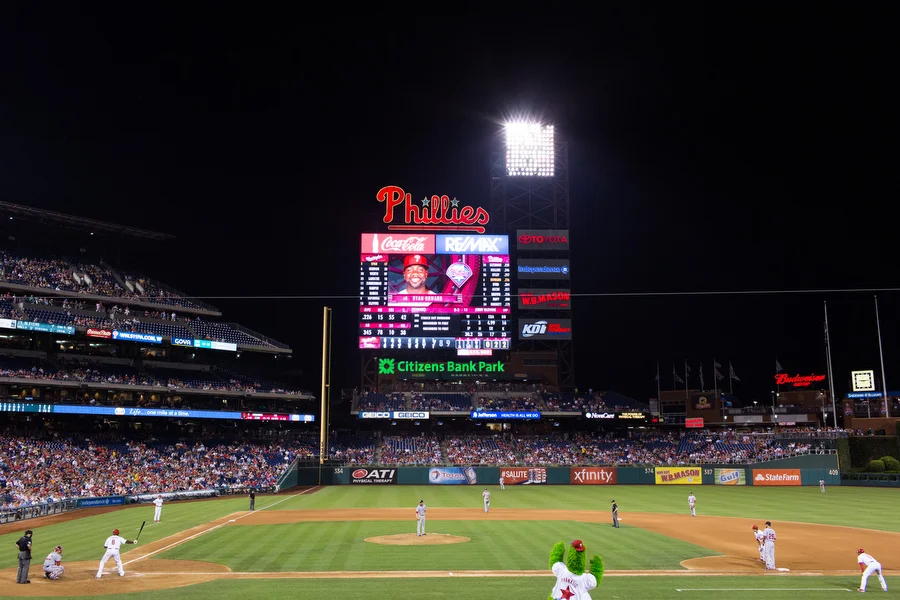 Ryan Howard bats while the Phillie Phanatic tries to distract the pitcher. 