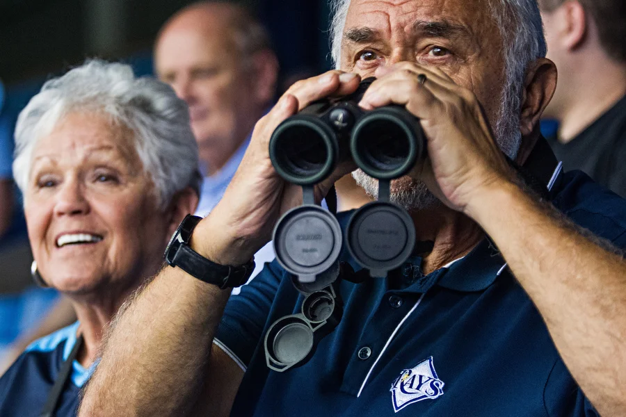 Carol and John watch the game. 