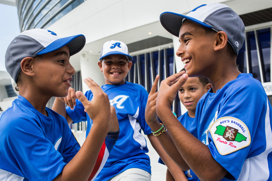 Members of the Aces 10U baseball team from Puerto Rico play hand games before the Marlins game.