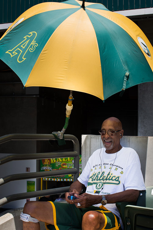 Larry has been coming to A's games since 1968, when the team moved to Oakland. He's built a contraption that latches onto a piece of the bleachers and keeps an umbrella above his head. "I love the sun, but you bake," he said. "I used to hold an umbrella but I said there's got to be a better way." He remembers the 1970s fondly, recalling the "Hot Pants Day" promotion in which you were granted free entry to the game if you wore hot pants. 