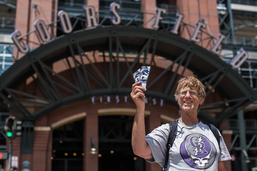 Gary is a long-time ticket scalper who also designed the shirt he wore to the game. His sales pitch for selling the very good seats he was holding up: "Who wants to see the Rockies lose up close?" He said he loves the Rockies, but in rough years like this, "you've got to keep it light." 