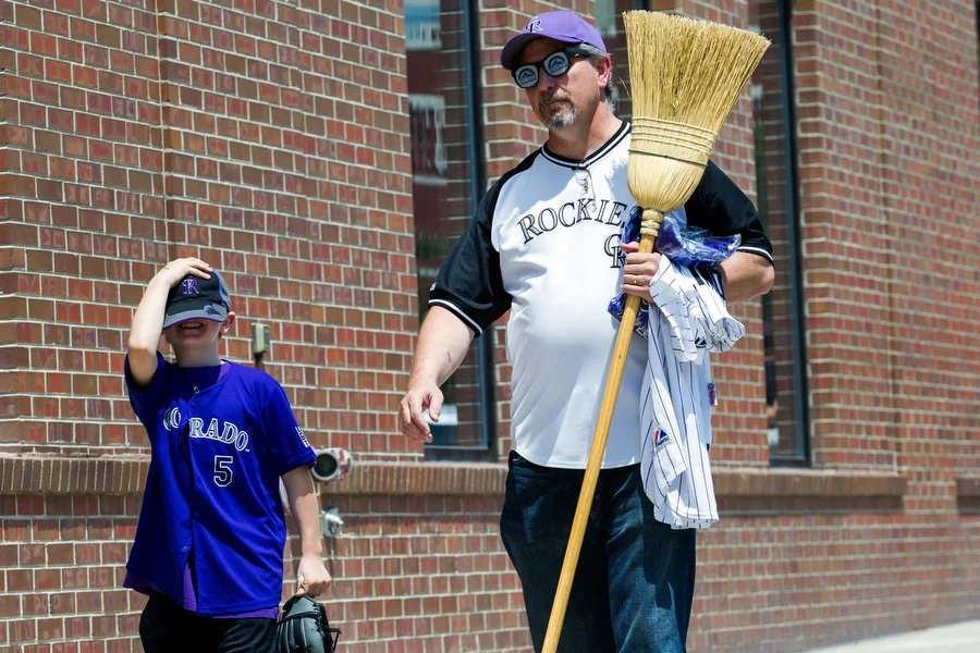 Doug and his grandson Caleb head to a restaurant before the game. Doug carried a broom because if the Rockies won on Sunday, they would sweep the visiting Pittsburgh Pirates. 