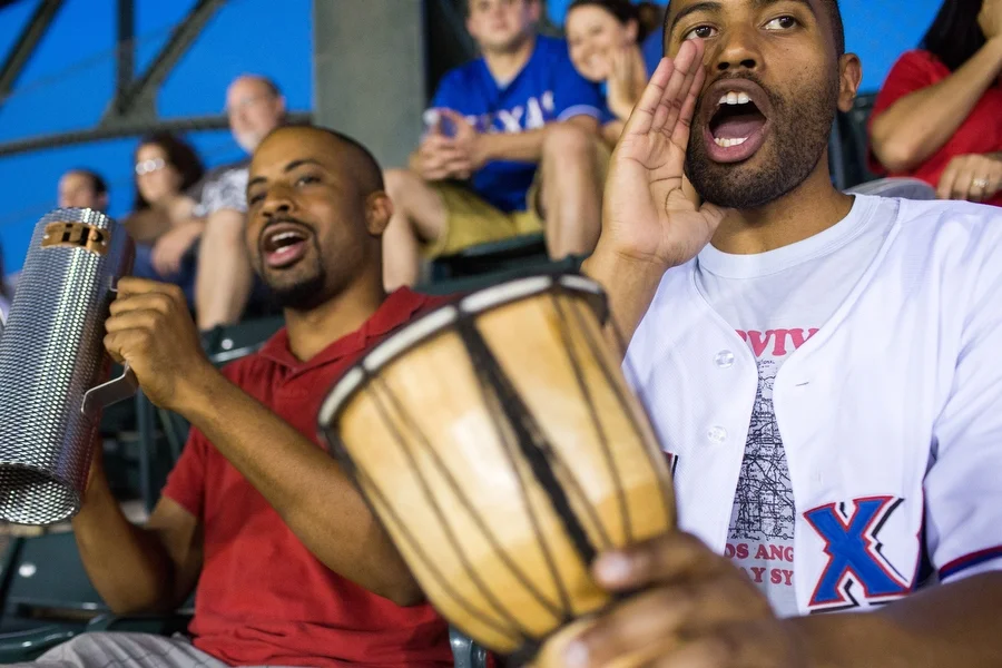 Alejandro plays la guira and Misael plays el tambor at the game, They said the culture of playing music in support of a team is much more common at baseball stadiums in other countries but they want to encourage the practice in the U.S. 