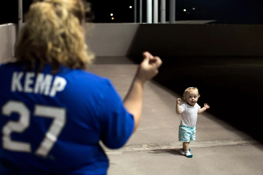 Rachelle and her daughter Isabella, 1, spend time away from the game on the outfield concourse. It was Isabella's first game. 