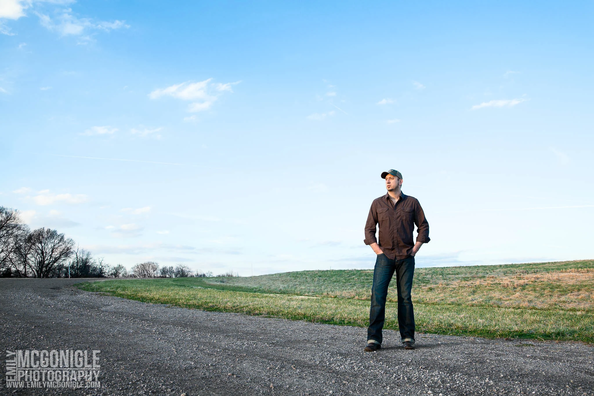 portrait in field with blue sky and clouds