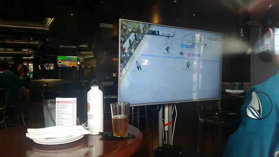 Fans inside AFAK Gamer Lounge playing as the Sharks vs. Pens (setup in the main window facing the street)