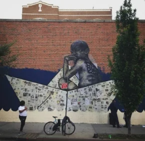 CAW Youth Employee Elsei Vidal in front of Viajero's mural in progress at PS 102 in El Barrio. Photo copyright MonumentArt.