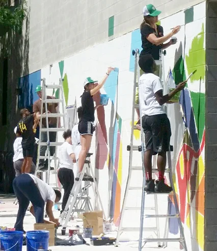 Youth Apprentices at work on CAW's third mural for PAL Harlem Center.