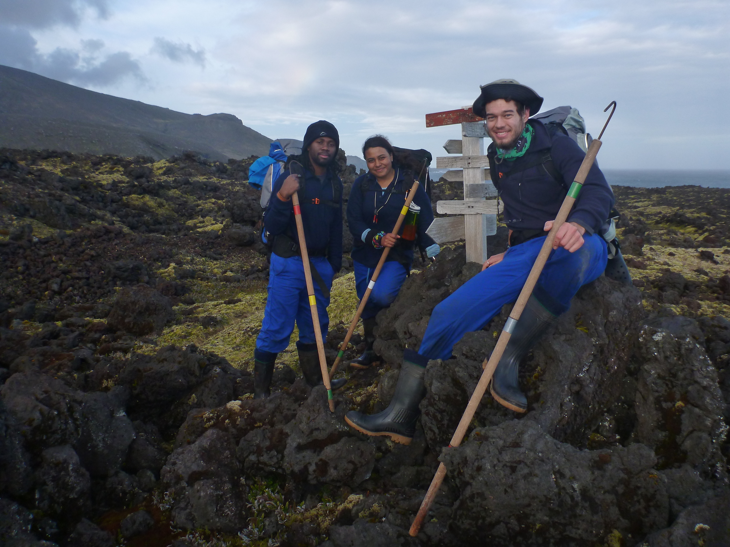 The 'newbie' 2016/2017 overwintering sealers/whalers: L-R Sydney Tshilingalinga, Nasreen Khan & Kyle Lloyd; next to the Cat hunter memorial signpost in Santa Rosa Valley, Marion Island. Photo: Nico de Bruyn 