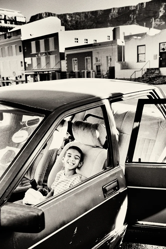 Streetportrait, smiling boy in car, capetown