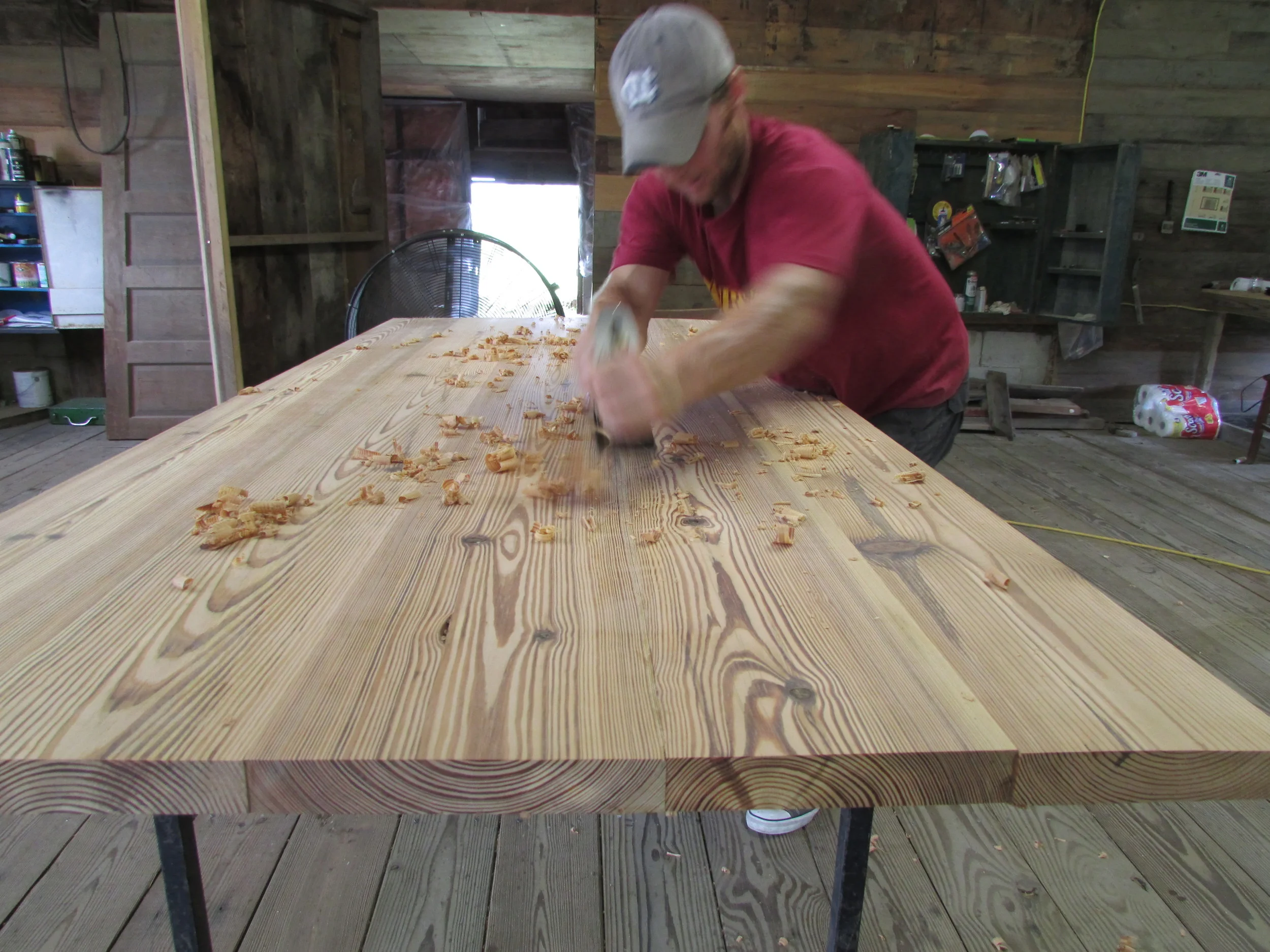 Matt Noble planing a table top
