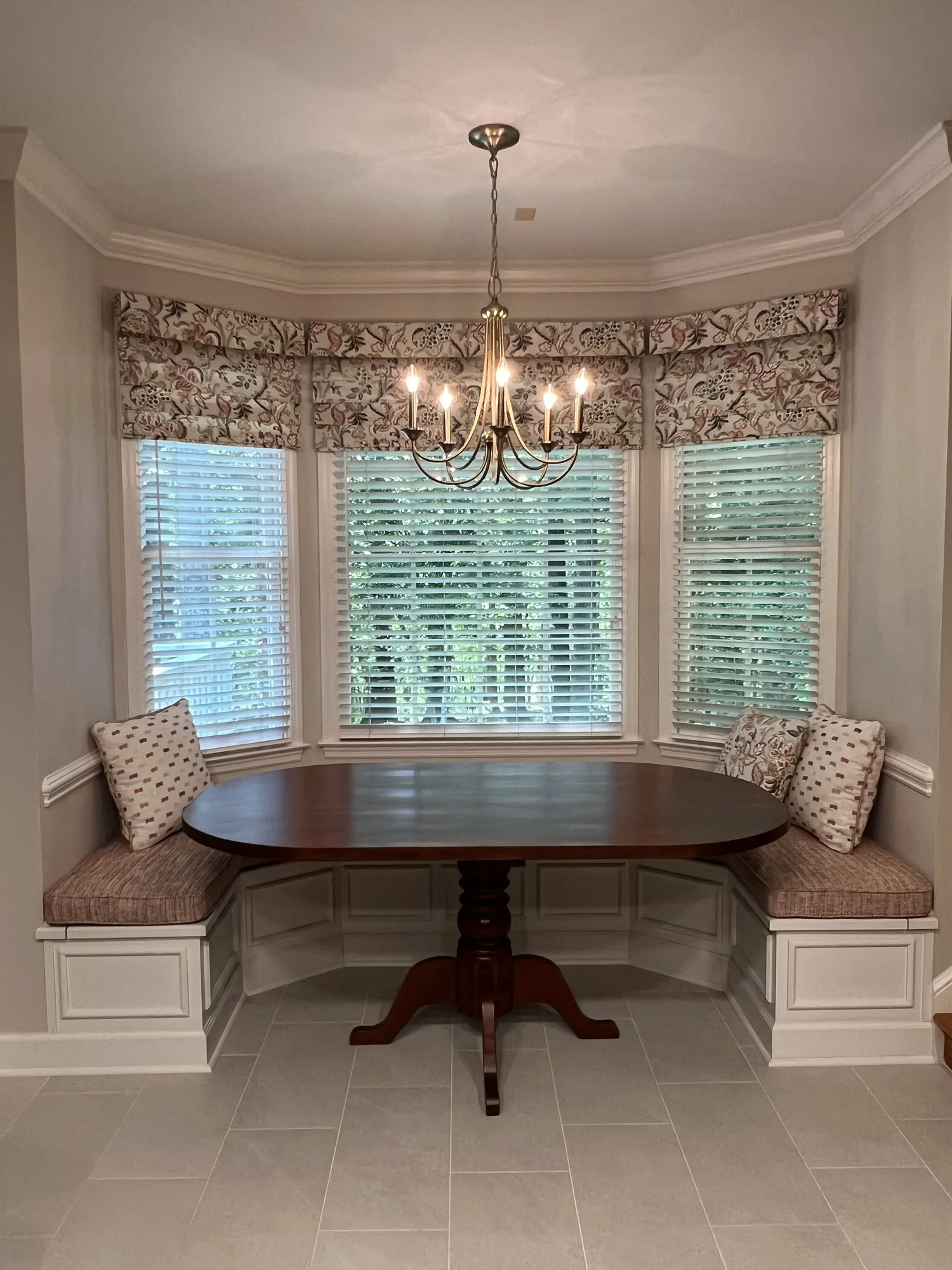 Custom oval dining table designed to fit built-in banquette seating
