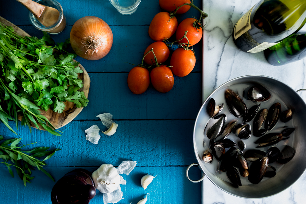 Tomatoes, onions, garlic, cilantro, tarragon and wine to make steamed mussels.