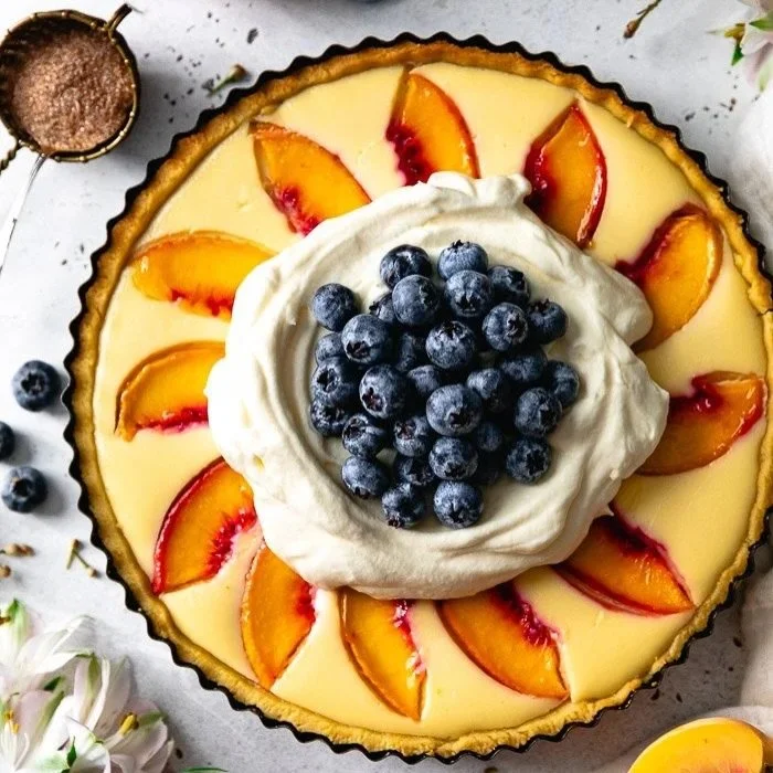 You know that dessert that makes you smile before the first bite? That&rsquo;s this Peach Cheesecake Tart. Flaky crust, creamy cheesecake, sweet peaches, a touch of cinnamon sugar, and whipped cream with blueberries. Spring never tasted this good!! ?