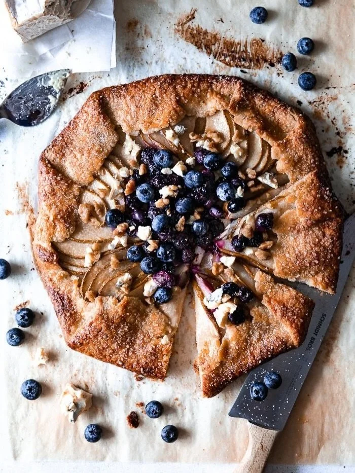 This pear and blueberry rustic tart is flaky, buttery, and simply so good! The blueberries add a sweet tart pop that pairs perfectly with the pears and a layer of sweet cream cheese that keeps the crust crisp and adds richness. The best part is the b