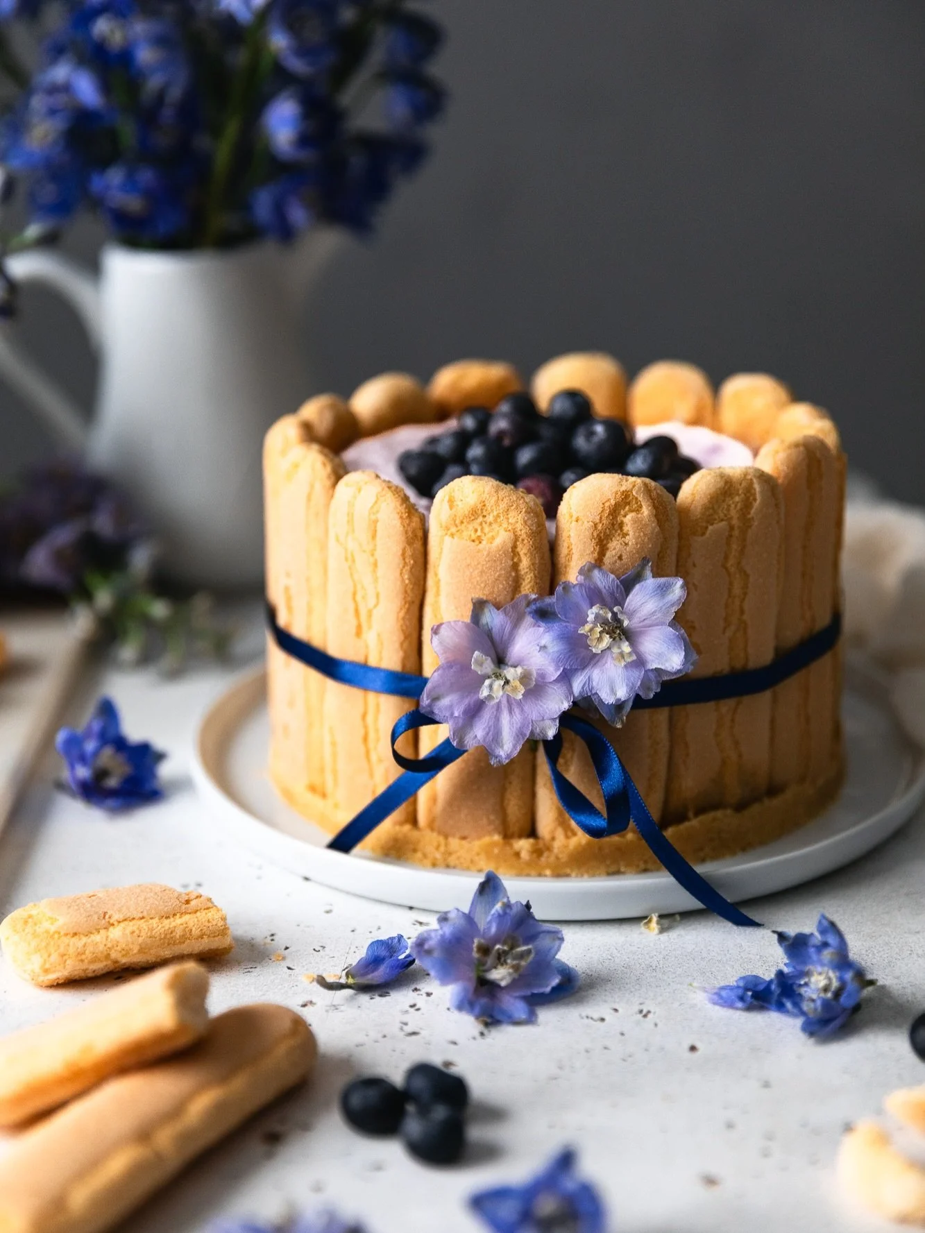 I have to say this No-bake Blueberry Charlotte Cheesecake melted my heart since the moment I wrapped that thin shiny ribbon around it. You will really be mesmerized by how easy it is to make but how beautiful it ends up! It feels light and refreshing